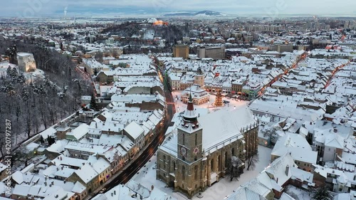 Brasov, Romania. Black Church( Biserica Neagra) and Old Town at twilight during Christmas.
