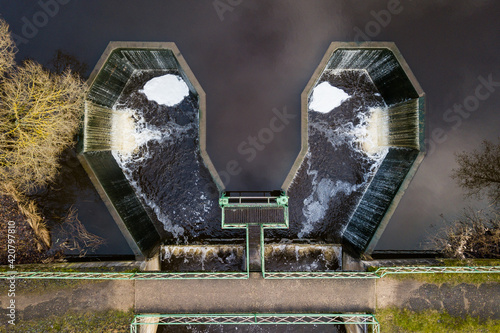 Aerial view of maple leaf shape sluice on a water mill pond in Ezere, Latvia photo