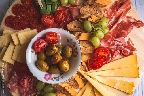 Italian food - wooden board of italian snacks