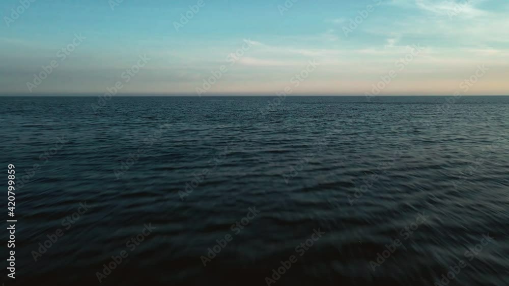 Drone moving fast into the sea after sundown Drone moving fast into the sea after sundown
