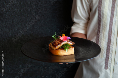 Foie Gras serving with toasted bread and green salad