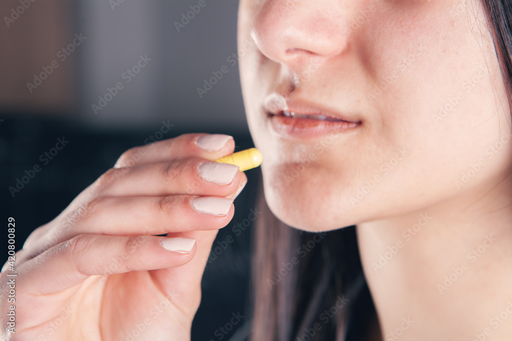 closeup woman hand holding pills closeup woman hand holding pills