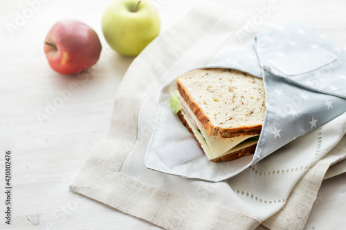 Whole grain sandwich wrapped in reusable bag. Zero waste ecologic concept