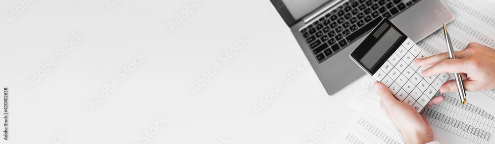 Businessman working with using a calculator to calculate the numbers. Finance accounting concept Businessman working with using a calculator to calculate the numbers. Finance accounting concept