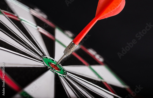 Red dart arrow on center of dartboard. Concept o business target, success and win.