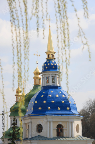 Orthodox church is sunlit in the middle of spring park photo