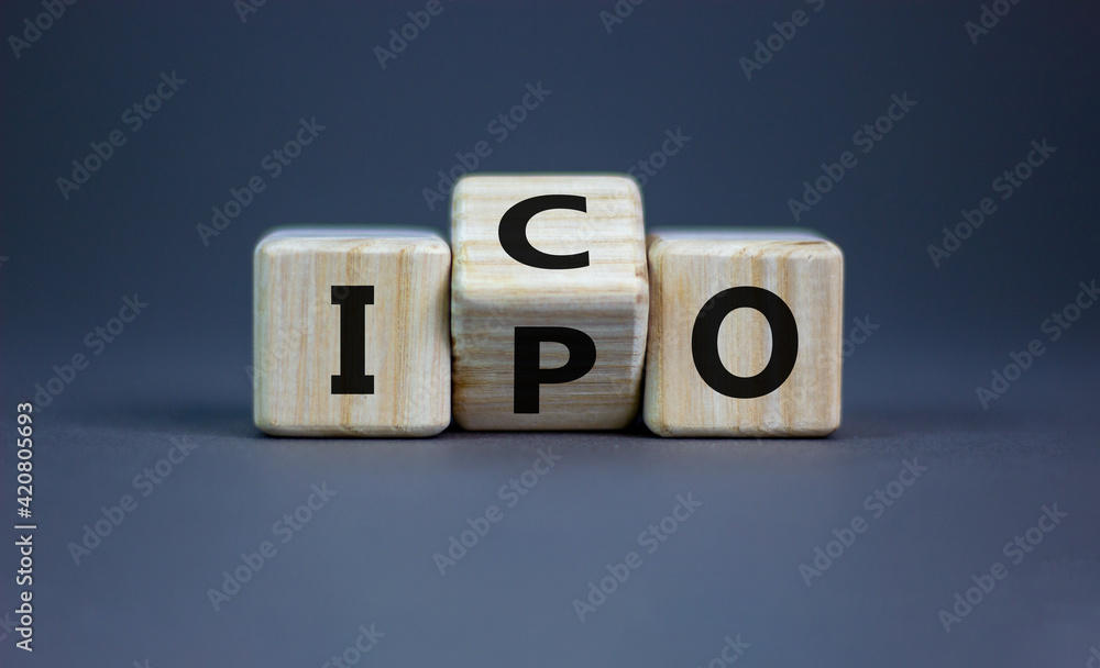 IPO vs ICO. Turned a cube and changed the word 'IPO - initial public offering' to 'ICO - initial coin offering'. Beautiful grey table. Grey background. Business and IPO vs ICO concept. IPO vs ICO. Turned a cube and changed the word 'IPO - initial public offering' to 'ICO - initial coin offering'. Beautiful grey table. Grey background. Business and IPO vs ICO concept.