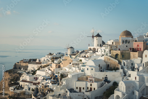 The famous Santorini windmills view with Aegean sea in the background. Sunset in Oia village. Greek destinations