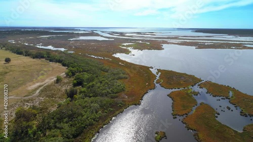Forward drone flight over salty lake near ocean in Gippsland, Australia