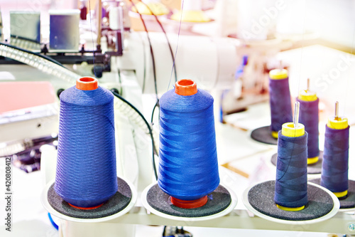 Spools of thread and sewing machine photo