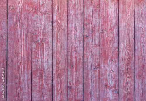 Old wooden background with peeling red paint