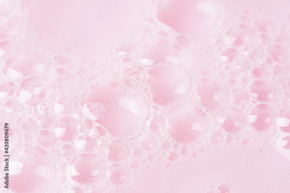 Foamed surface of pink liquid soap, small bubbles, closeup Foamed surface of pink liquid soap, small bubbles, closeup
