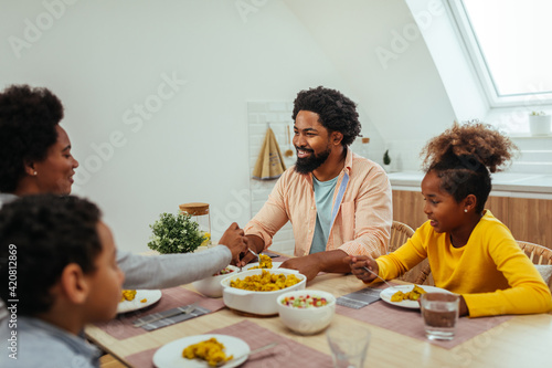 Afro family eating together at home