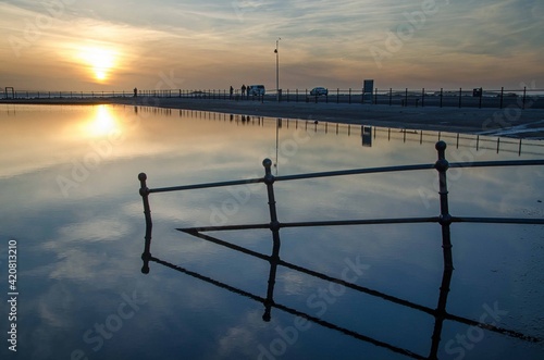 Reflection of hand rails as they decend into the boating lake photo