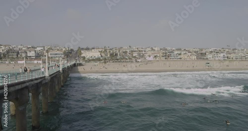 Wallpaper Mural Sunny day at Manhattan beach viewed from a pier, full with surfers and swimmers Torontodigital.ca
