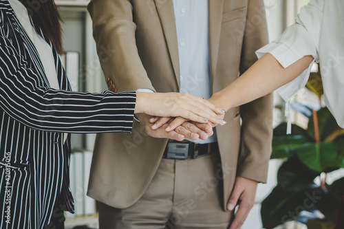 Close up hand of group young businessman, businesswoman people putting hand together,startup power to support, success or done at office,workplace.Teamwork, colleagues collaborate business concept.