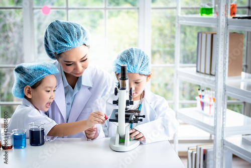 Asian attractive woman  teacher Scientific experiments are being performed for children students in the laboratory, to education and science concept.