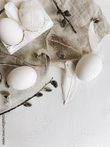 Photography Natural easter eggs, feathers, pussy willow branches on rustic cloth on white aged table