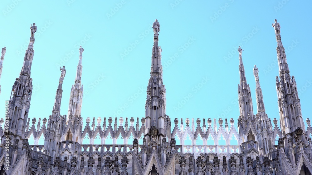 Milan , Italy march 2021  - spiers of the cathedral ( Duomo ) in a sunny day with blue sky during covid-19 Coronavirus lockdown quarantine home 