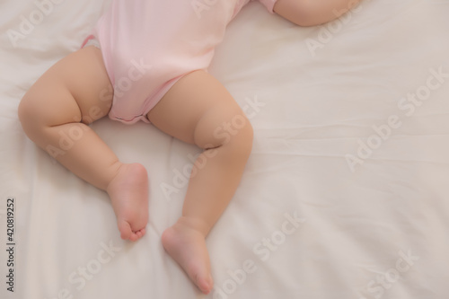 Adorable cute toddler or baby sleeping on bed at night sweet dream in bedroom Lovely child get deep sleep and get relax and comfortable during lay down on bed Little toddler girl legs selective focus