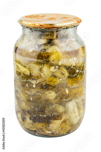 old pickles in glass jar with rusted cap in bad condition isolated on white background photo