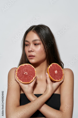 Beautiful girl with fruits in the studio