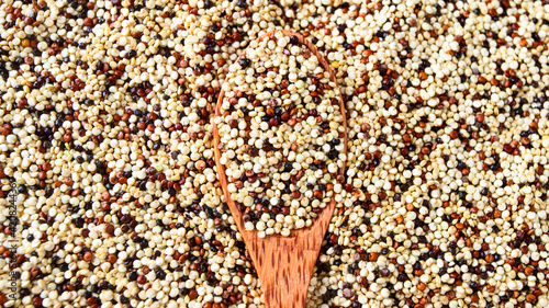 Fotografi Different quinoa grains  on wooden spoon