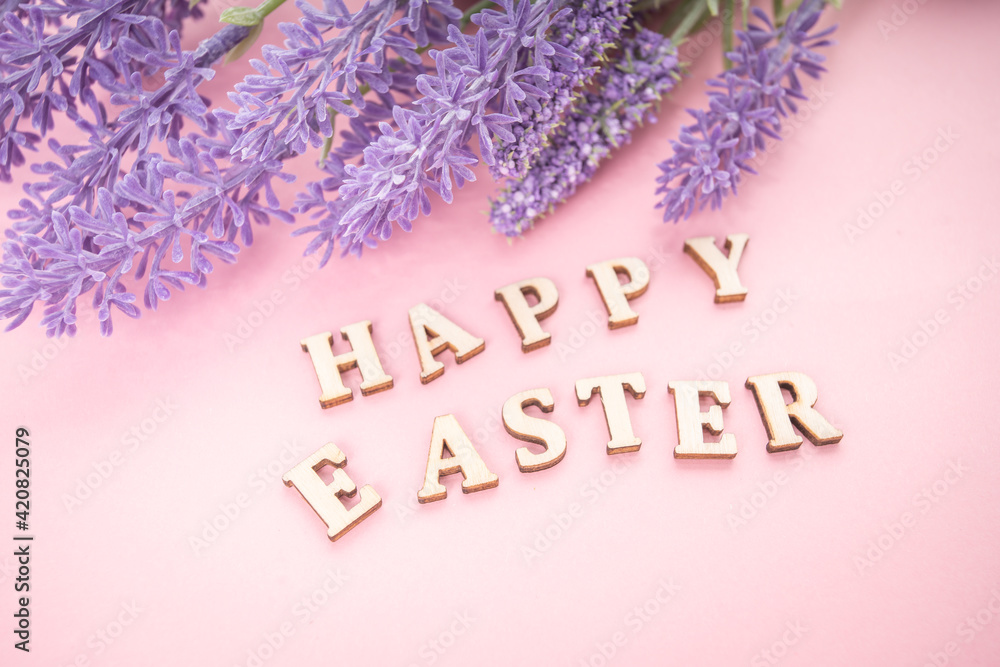 Fototapeta premium Happy Easter text on rose background.