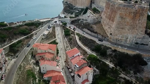 Drone flies over the Citadelle and the town of Bonifacio on the island of Corsica built on cliffs, France.