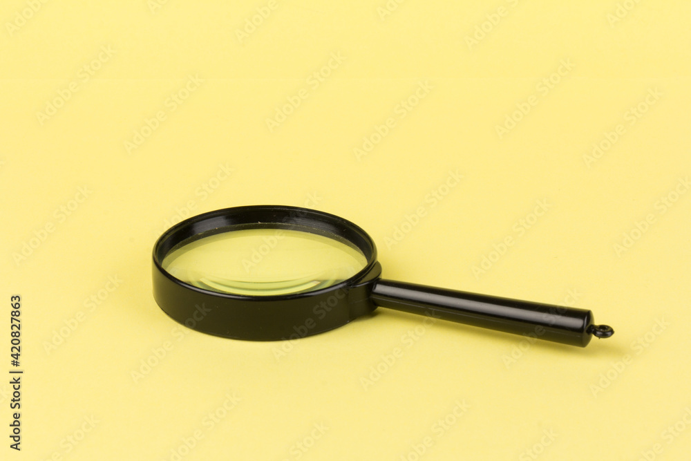 magnifying glass loupe search symbol on yellow background with copy space magnifying glass loupe search symbol on yellow background with copy space