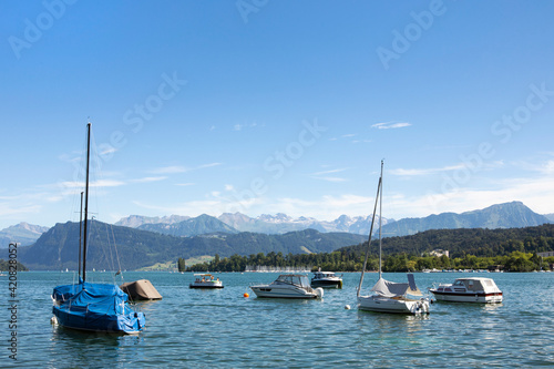 Panorama of Lake Lucerne, yachts in the water, view on Alps mountains, summer day. Switzerland © MindestensM