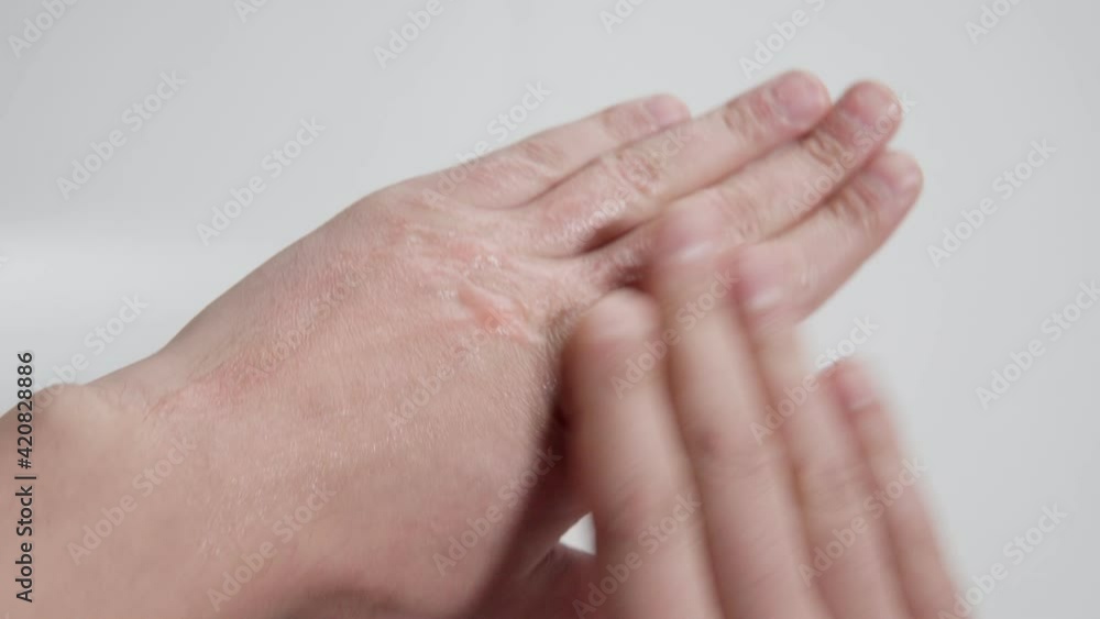 man applying a hand cream to his hand. close-up selective focus man applying a hand cream to his hand. close-up selective focus