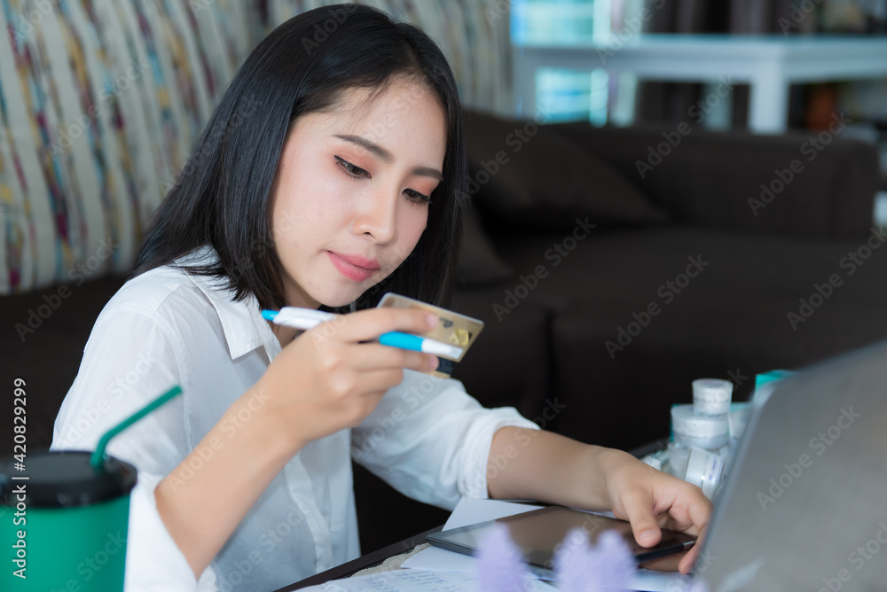 Beautiful asian woman shopping online at home Beautiful asian woman shopping online at home