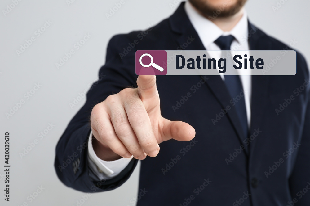 Man pointing at search bar with request Dating Site on light grey background, closeup Man pointing at search bar with request Dating Site on light grey background, closeup