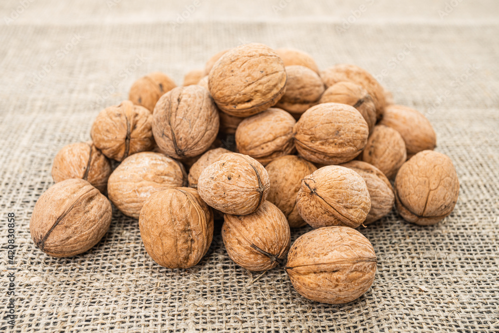 Close up view of walnuts on tabletop Close up view of walnuts on tabletop
