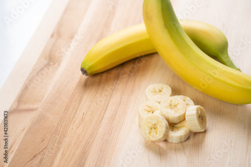 Bananas on wooden cutting board