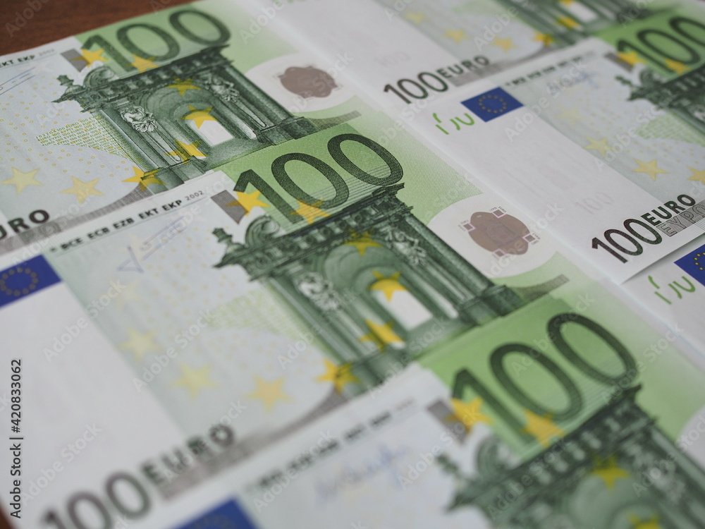 Many new 100 Euro banknotes are neatly arranged in rows Many new 100 Euro banknotes are neatly arranged in rows