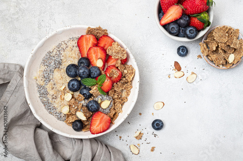 Bowl of fresh homemade oatmeal porridge with berries. Healthy food for Breakfast.