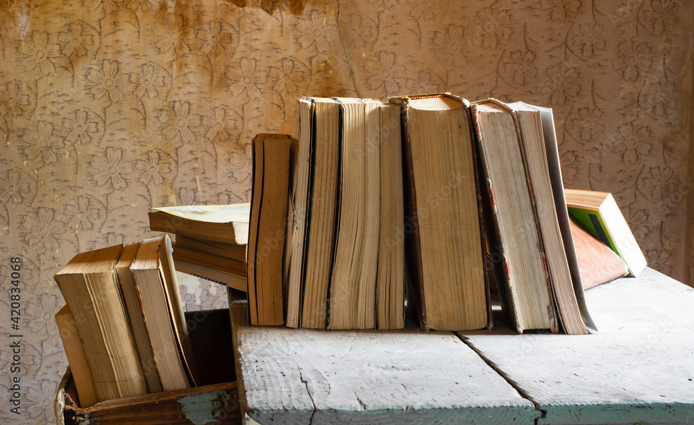 old books abandoned on an old wooden table