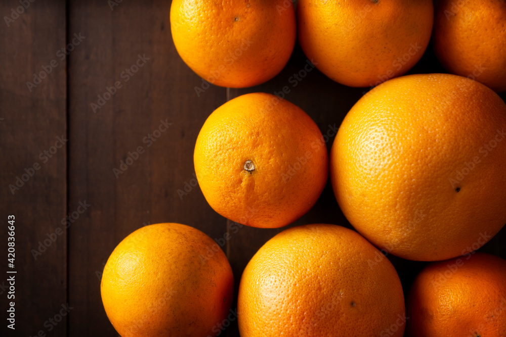 top view image of several whole oranges on broun rustic wooden table with copy space top view image of several whole oranges on broun rustic wooden table with copy space