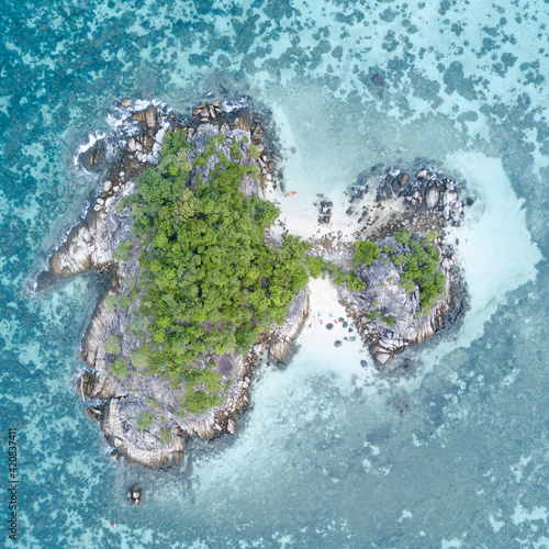 Stunning summer landscape. Aerial view of turquoise Andaman sea with reef and small island at Koh Lipe or Lipe island, Satun, Southern Thailand. Top view shot from drone
