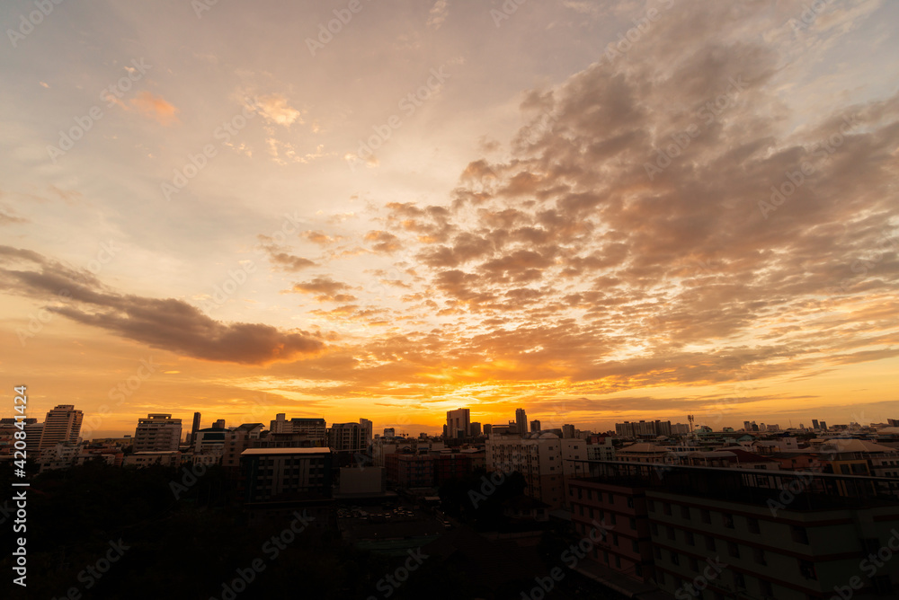 Fototapeta premium Golden light of the sunset over the city.