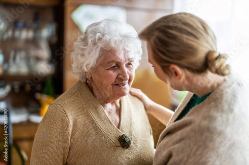 Health visitor talking to a senior woman during home visit
 photo