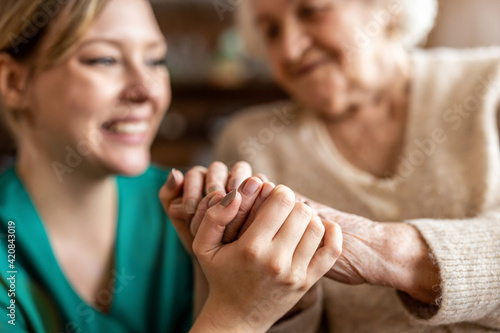 Cropped shot of a senior woman holding hands with a nurse

 photo