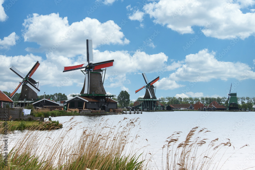 A Dutch photo of the windmills of the Zaanse Schans, on a beautiful day with clouds