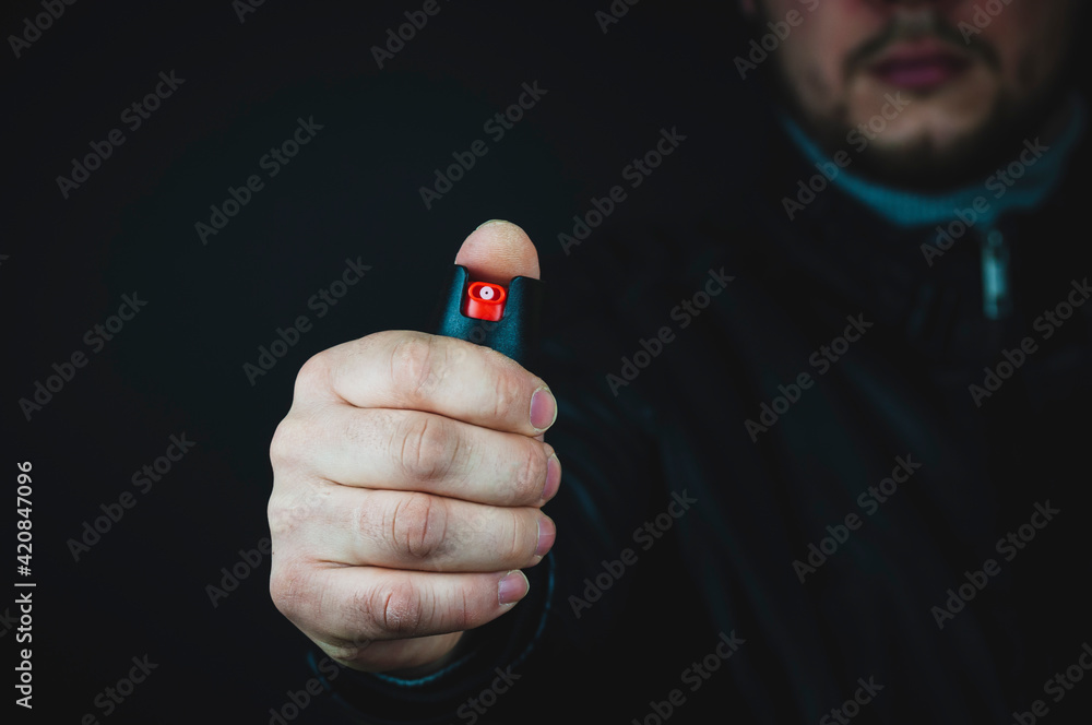 Fototapeta premium gas canister in hand, self-defense concept