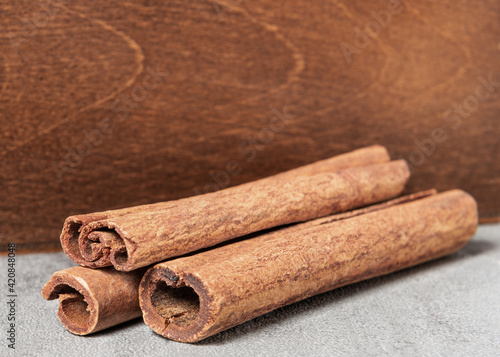 Cinnamon sticks on a wooden background.