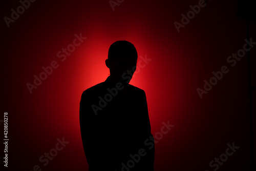Silhouette of a man on a red background.