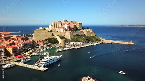 Citadel of Calvi with the port and the Mediterranean Sea, Corsica France. Drone takes off in front of the Citalle