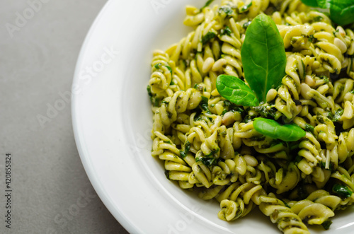 Pesto and pine nut pasta salad, fusilli pasta with regato cheese and baby spinach coated in basil pesto